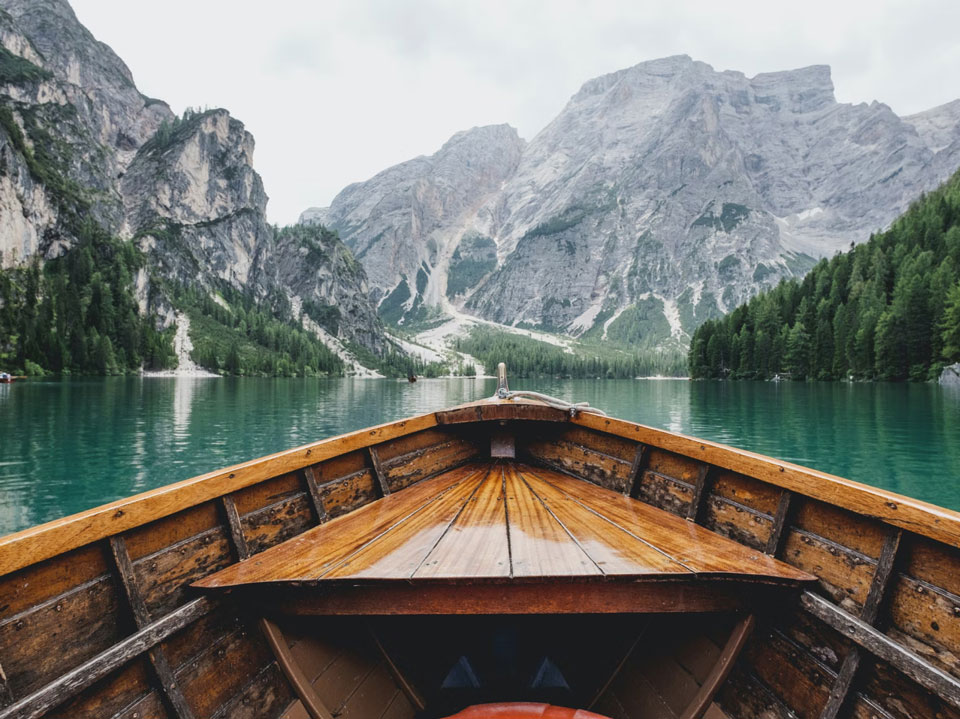 A boat on a lake surrounded by mountains